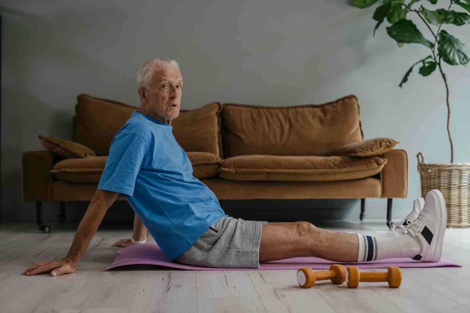 Senior performing strength training exercises at home